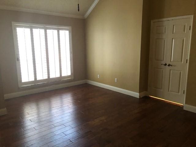 empty room with crown molding, plenty of natural light, baseboards, and dark wood finished floors