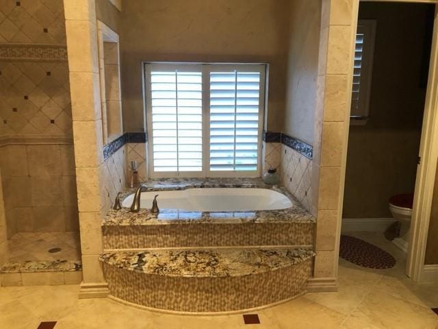 full bath with toilet, a bath, tile patterned floors, and tiled shower