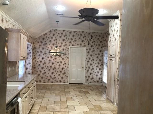 kitchen featuring ornamental molding, a ceiling fan, wallpapered walls, lofted ceiling, and baseboards