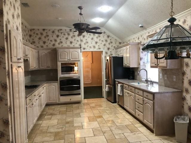 kitchen with stainless steel appliances, wallpapered walls, ceiling fan, a sink, and crown molding