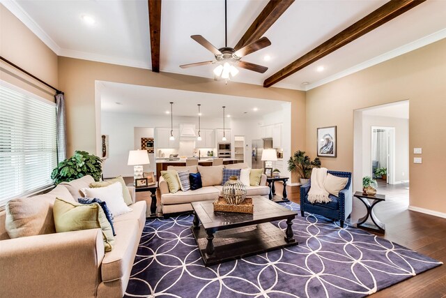 living area featuring dark wood-type flooring, a ceiling fan, beam ceiling, recessed lighting, and ornamental molding