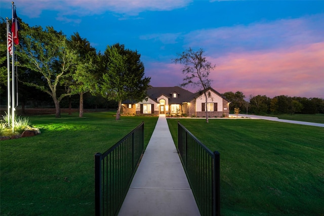 view of front of home featuring a front yard and brick siding