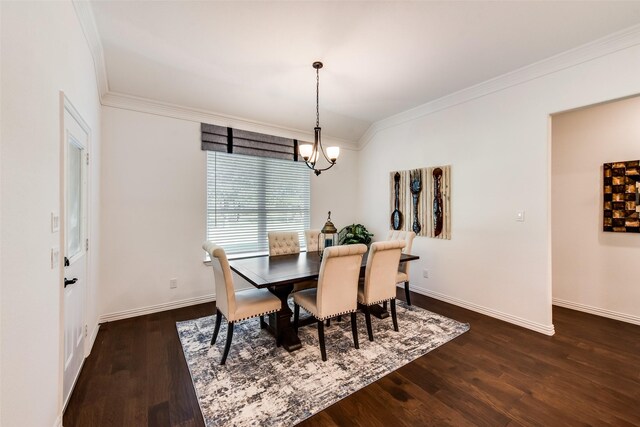 dining space featuring ornamental molding, dark wood-style floors, a chandelier, and baseboards