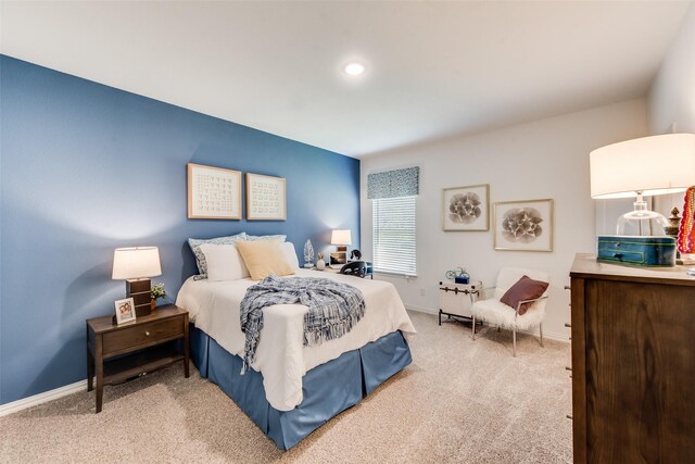 carpeted bedroom featuring baseboards