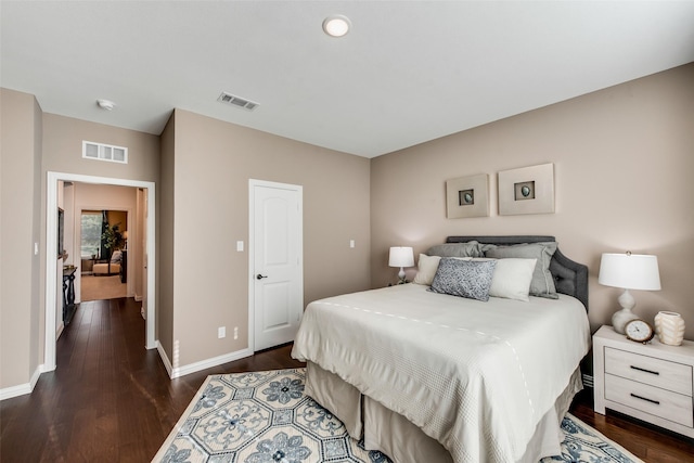 bedroom featuring dark wood finished floors and baseboards
