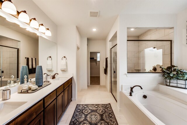bathroom with a stall shower, a bath, double vanity, recessed lighting, and marble look tiles