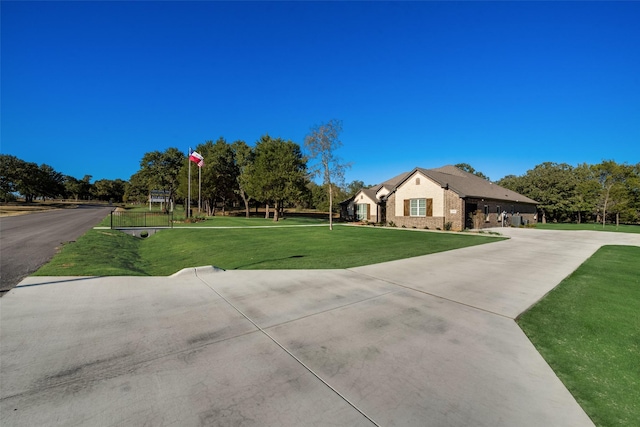 ranch-style house with a front yard and curved driveway
