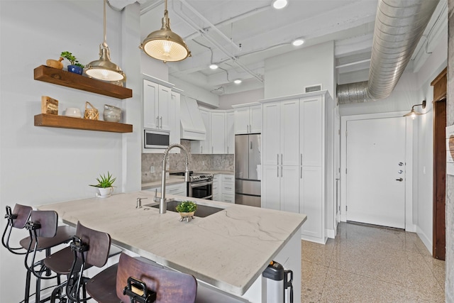 221 W Lancaster Ave Unit 4012, Fort Worth, TX 76102 - kitchen with stainless steel appliances, a sink, white cabinetry, a breakfast bar, and recessed lighting