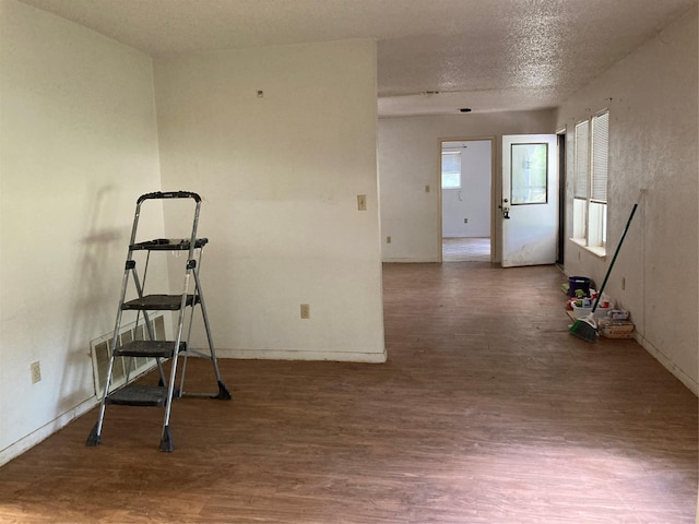 12735 County Road 2922, Eustace, TX 75124 - workout room featuring wood finished floors, baseboards, and a textured ceiling