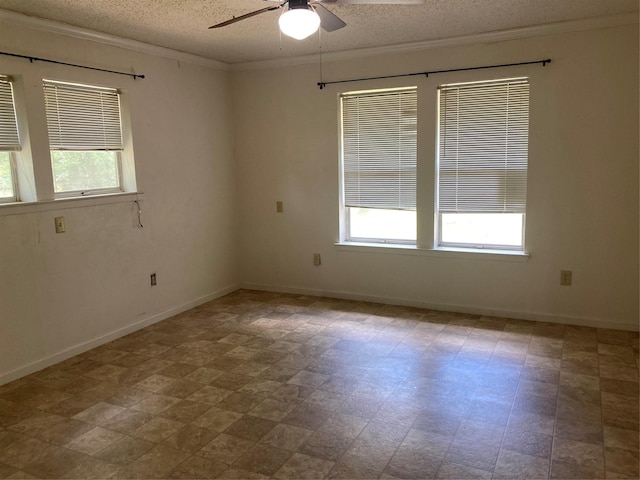 12735 County Road 2922, Eustace, TX 75124 - empty room with a ceiling fan, plenty of natural light, a textured ceiling, ornamental molding, and baseboards