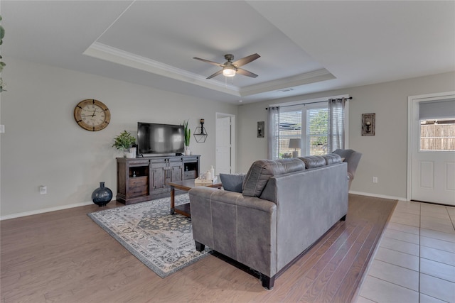 2208 Heaton St, Forney, TX 75126 - living room with a tray ceiling, light wood finished floors, ceiling fan, baseboards, and crown molding