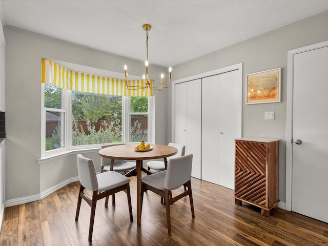 dining room with a chandelier, dark wood-type flooring, and baseboards