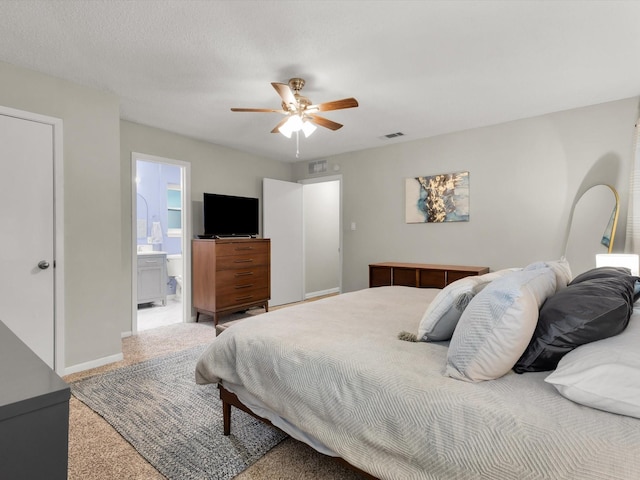 carpeted bedroom featuring a ceiling fan, baseboards, and connected bathroom