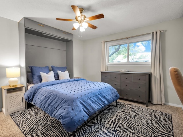 carpeted bedroom with baseboards and a ceiling fan