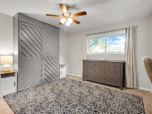 bedroom with light carpet, baseboards, and a ceiling fan