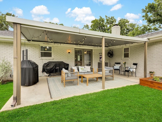 rear view of property with an outdoor hangout area, brick siding, a chimney, a lawn, and a patio