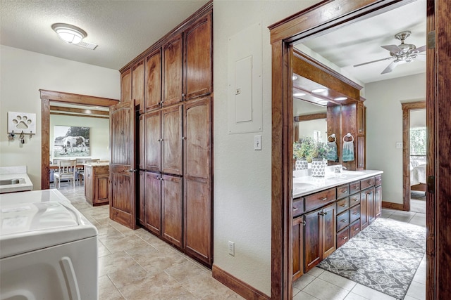 7265 Mcgregor Park Rd, Temple, TX 76502 - laundry room featuring washer / dryer, baseboards, cabinet space, ceiling fan, and a textured ceiling
