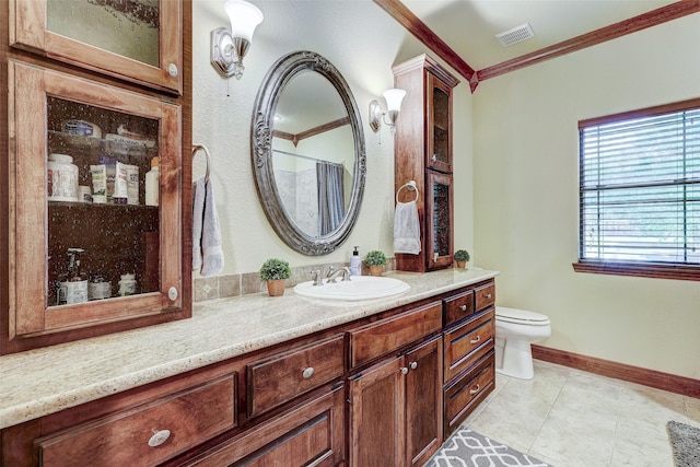 full bathroom featuring crown molding, vanity, baseboards, toilet, and tile patterned flooring