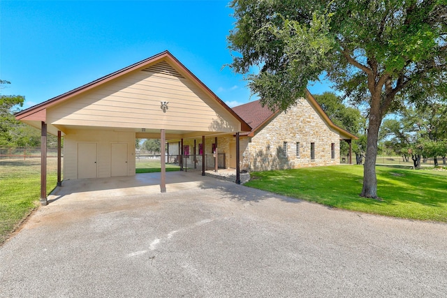 view of front facade with a carport, driveway, and stone siding