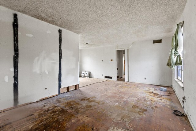 64 Pershing Dr Unit A & B, Denison, TX 75020 - spare room with a textured ceiling