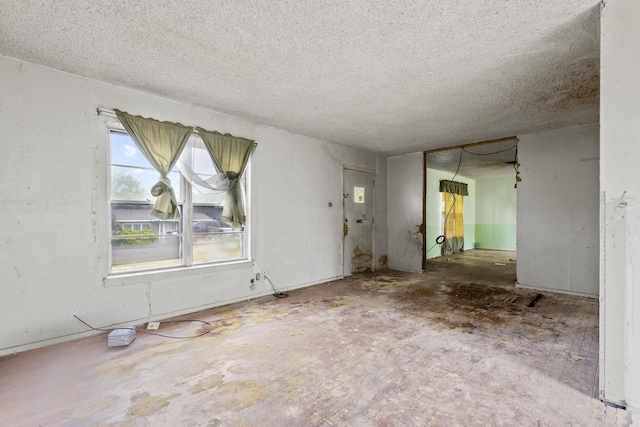 64 Pershing Dr Unit A & B, Denison, TX 75020 - unfurnished living room with a textured ceiling