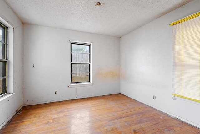 64 Pershing Dr Unit A & B, Denison, TX 75020 - spare room featuring wood finished floors and a textured ceiling