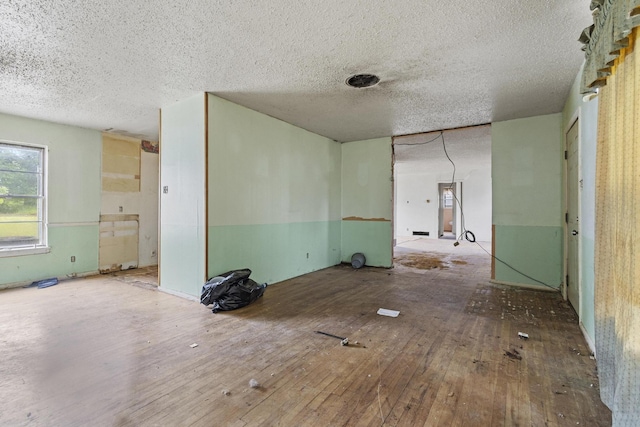 64 Pershing Dr Unit A & B, Denison, TX 75020 - unfurnished room featuring wood-type flooring and a textured ceiling