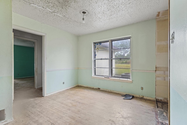 64 Pershing Dr Unit A & B, Denison, TX 75020 - empty room featuring wood finished floors and a textured ceiling