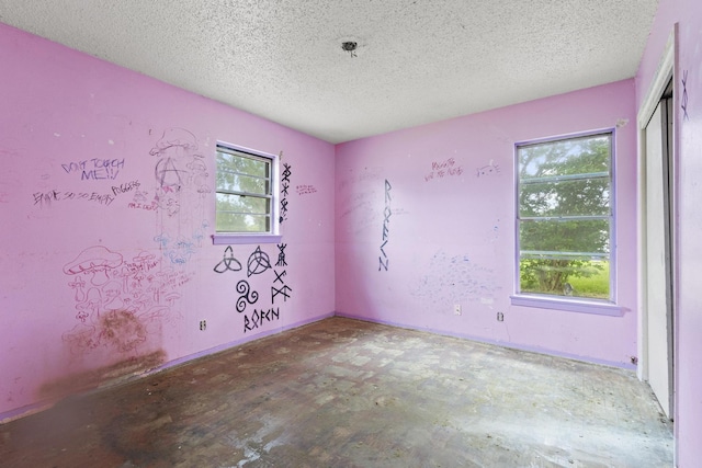 64 Pershing Dr Unit A & B, Denison, TX 75020 - spare room featuring a textured ceiling