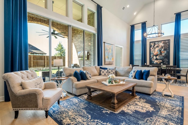 2200 Sandalwood Dr, Prosper, TX 75078 - living room with high vaulted ceiling, a chandelier, wood finished floors, and a ceiling fan