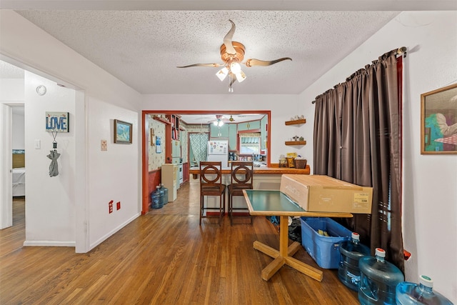 2924 Cole Ave, Waco, TX 76707 - dining room with ceiling fan, wood finished floors, a textured ceiling, and baseboards