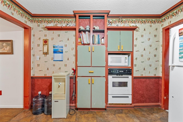 2924 Cole Ave, Waco, TX 76707 - kitchen with white appliances, wallpapered walls, a textured ceiling, a warming drawer, and ornamental molding