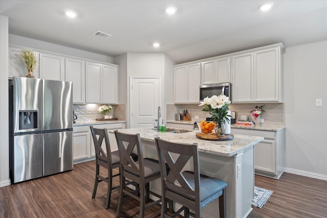 252 Rosewood Dr, Lavon, TX 75166 - kitchen featuring stainless steel appliances, a sink, dark wood-style floors, baseboards, and white cabinetry