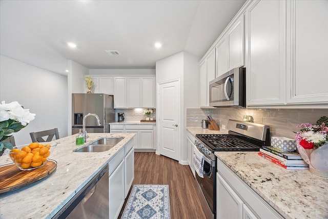 252 Rosewood Dr, Lavon, TX 75166 - kitchen featuring appliances with stainless steel finishes, a sink, white cabinetry, decorative backsplash, and recessed lighting