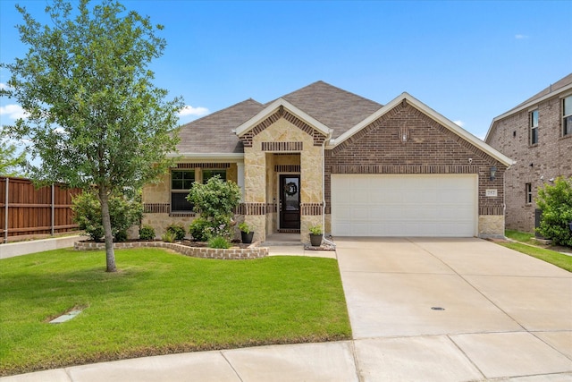 252 Rosewood Dr, Lavon, TX 75166 - view of front facade featuring stone siding, a garage, driveway, a shingled roof, and brick siding