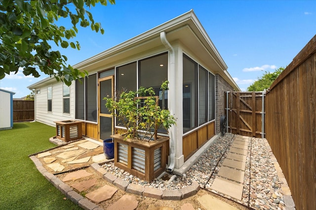 252 Rosewood Dr, Lavon, TX 75166 - view of home's exterior featuring a sunroom and a gate