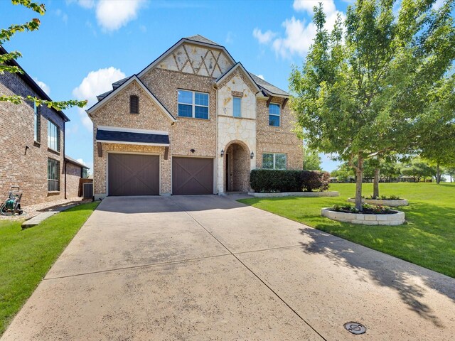 791 Bordeaux Dr, Rockwall, TX 75087 - doorway to property with driveway, a lawn, stone siding, and brick siding