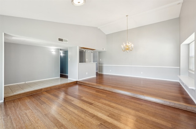 2848 Oxford Ln, Flower Mound, TX 75028 - unfurnished living room featuring wood finished floors, a chandelier, baseboards, and high vaulted ceiling