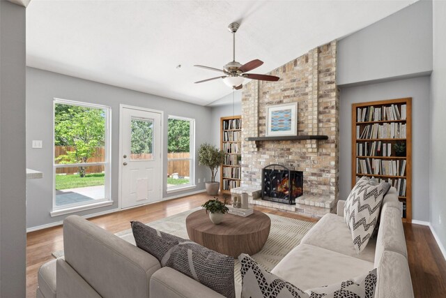 2848 Oxford Ln, Flower Mound, TX 75028 - living area with lofted ceiling, wood finished floors, a ceiling fan, a fireplace, and baseboards