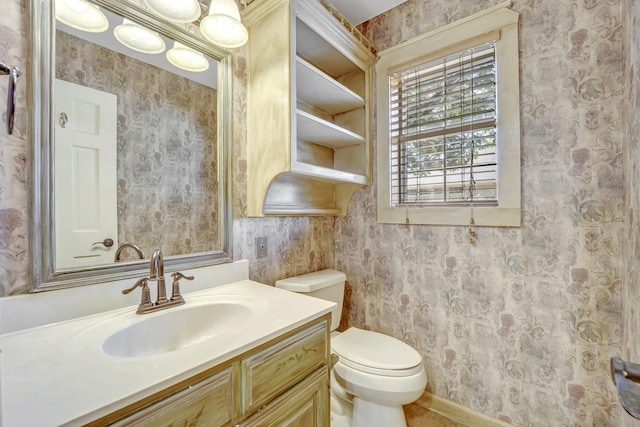 1700 Tall Timber Dr, Tyler, TX 75703 - bathroom featuring wallpapered walls, toilet, vanity, and baseboards