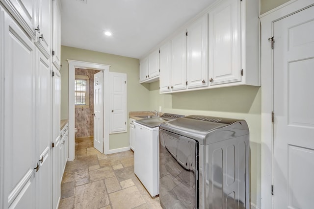 1700 Tall Timber Dr, Tyler, TX 75703 - clothes washing area featuring cabinet space, stone tile flooring, washer and clothes dryer, recessed lighting, and baseboards
