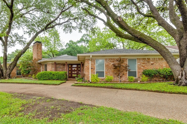 109 Tuscany Ct, Irving, TX 75062 - view of front of property with brick siding, a chimney, a shingled roof, and french doors