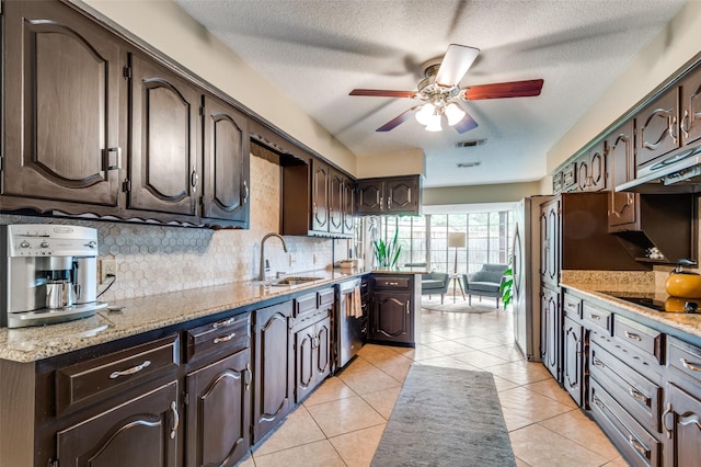 109 Tuscany Ct, Irving, TX 75062 - kitchen with a sink, a ceiling fan, dark brown cabinetry, black electric stovetop, and under cabinet range hood