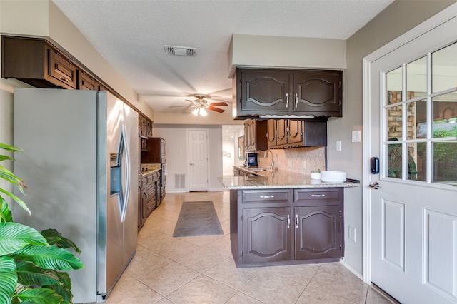 109 Tuscany Ct, Irving, TX 75062 - kitchen with stainless steel refrigerator with ice dispenser, a ceiling fan, light tile patterned flooring, tasteful backsplash, and dark brown cabinetry