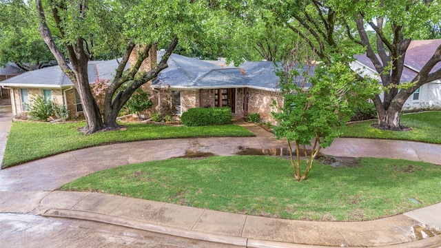 109 Tuscany Ct, Irving, TX 75062 - view of front facade with brick siding, a front lawn, and a chimney