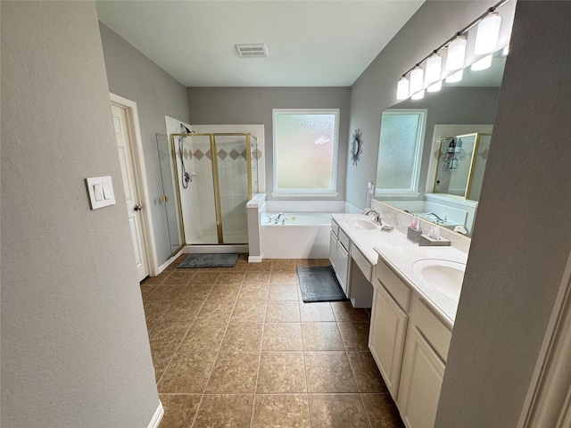 bathroom with a shower stall, a garden tub, tile patterned flooring, a textured wall, and double vanity