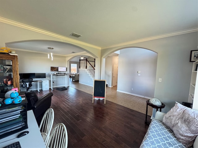 living area with arched walkways, crown molding, stairway, wood finished floors, and baseboards