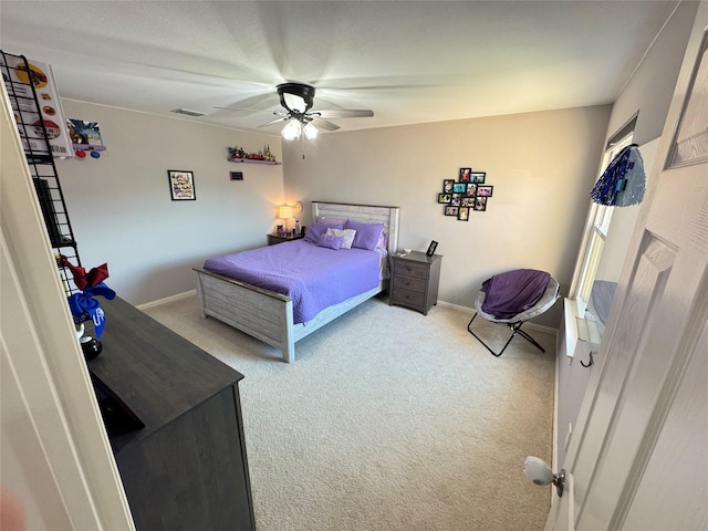 carpeted bedroom with a ceiling fan and baseboards