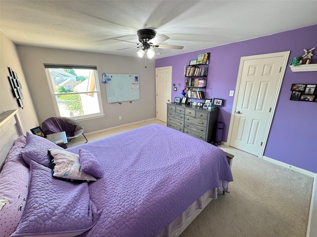 bedroom with carpet floors, a ceiling fan, and baseboards