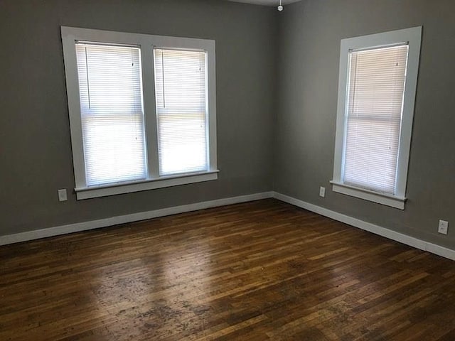 509 W Sears St, Denison, TX 75020 - unfurnished room with dark wood finished floors and baseboards